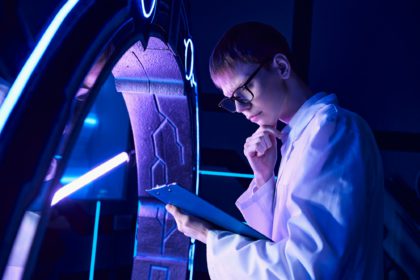 futuristic science, discovery center, young scientist with clipboard thinking at innovative device